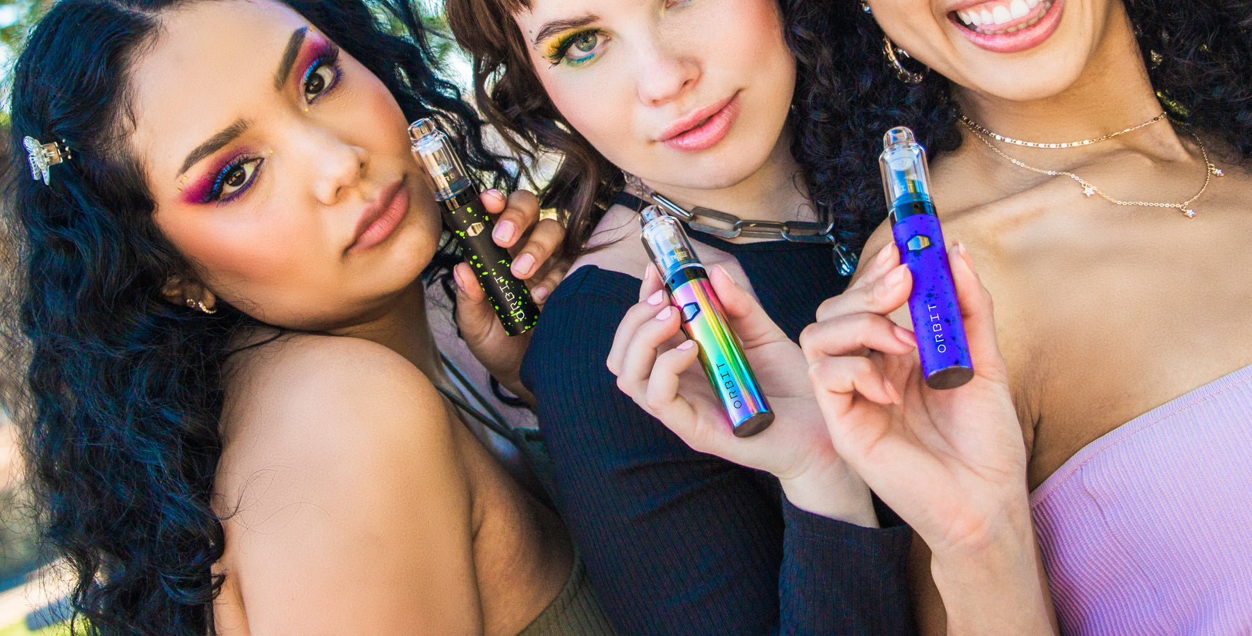 Three women holding Wulf Orbits at a park